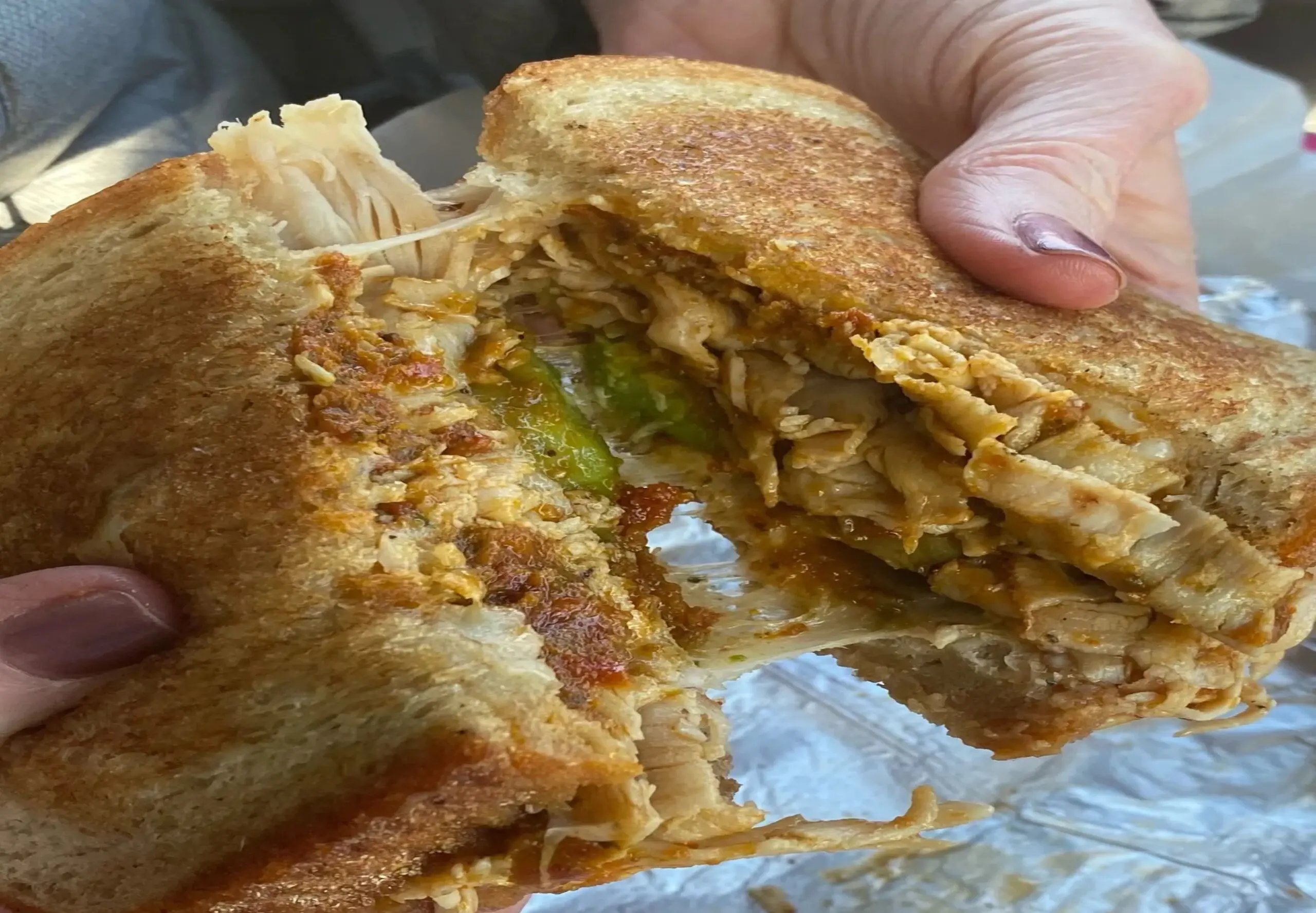 Grilled sandwich with shredded chicken filling.