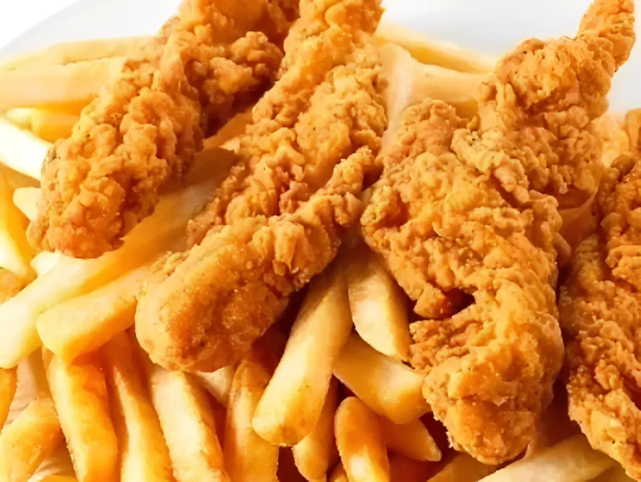 Fried chicken tenders and fries on plate.