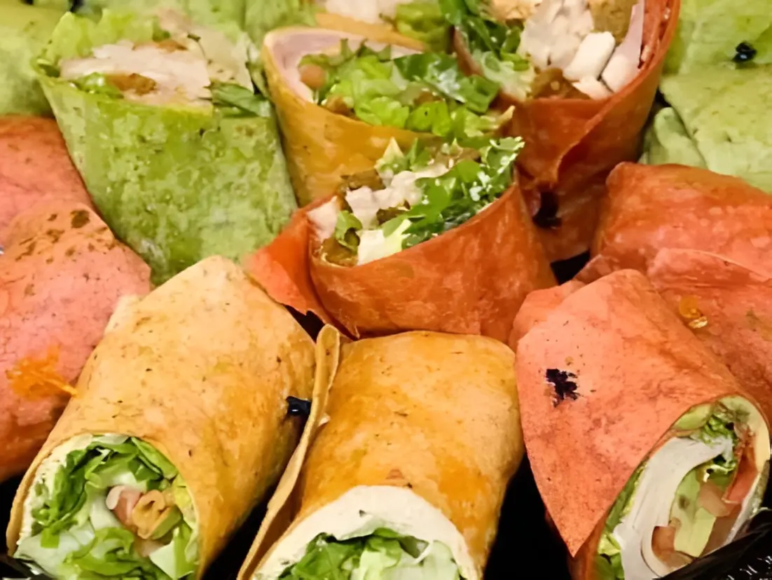 Assorted colorful wraps with fresh vegetables.
