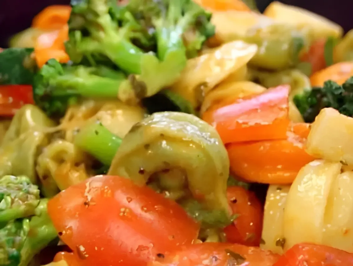 Colorful vegetable and pasta salad close-up.